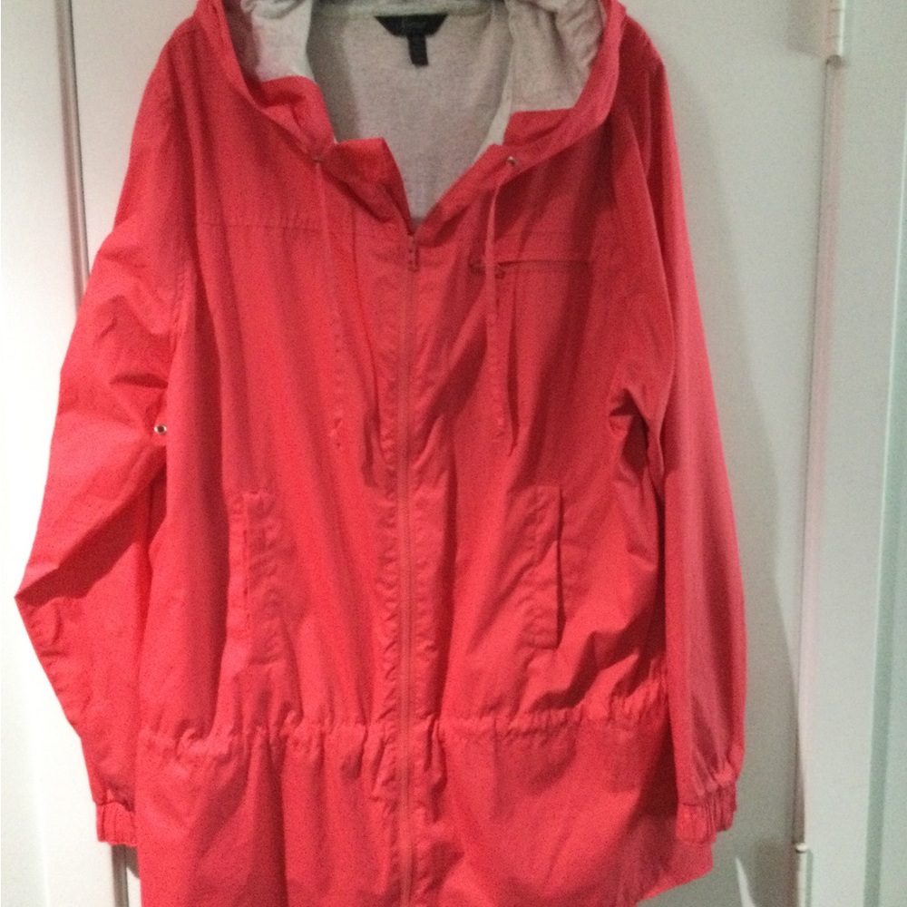 Soma bright coral lined windbreaker with hood and peplum detail.